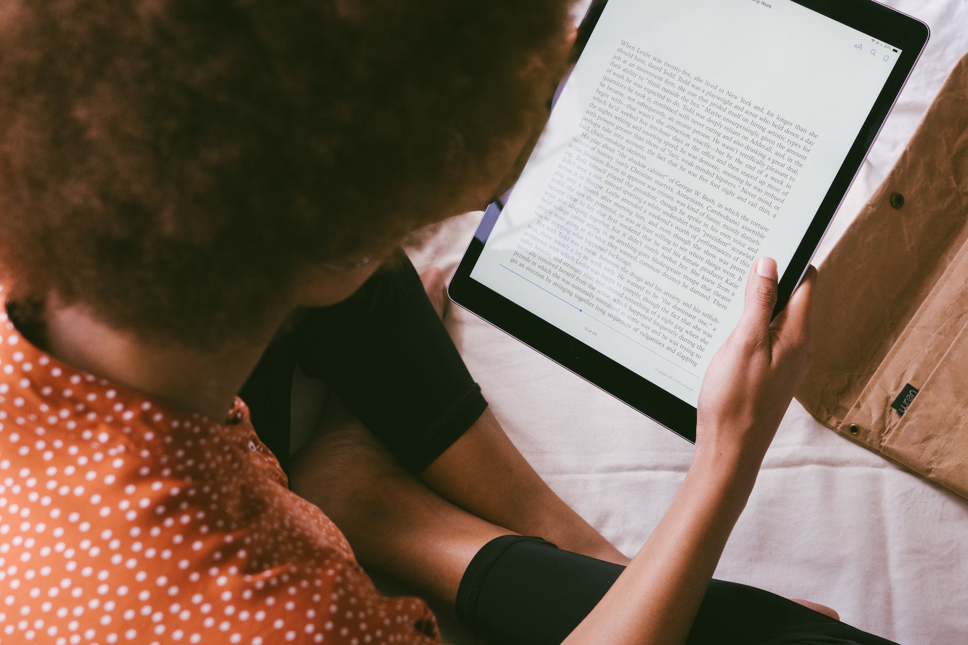 high angle photo of person reading an e book