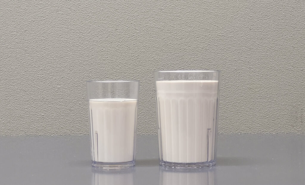 Two glasses of milk on a table
