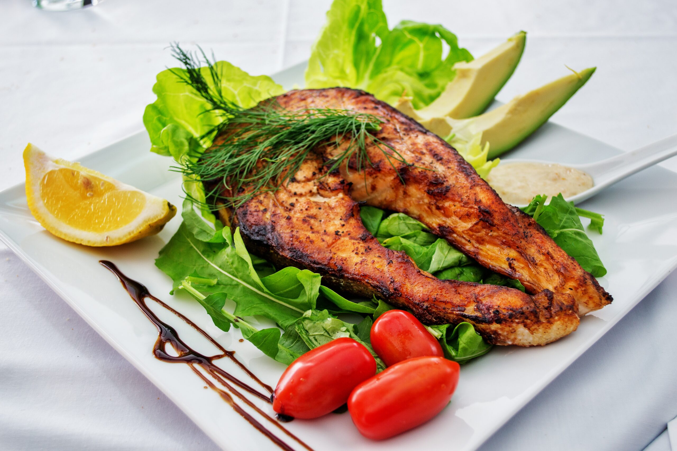 Grilled salmon fillet on a plate with vegetables